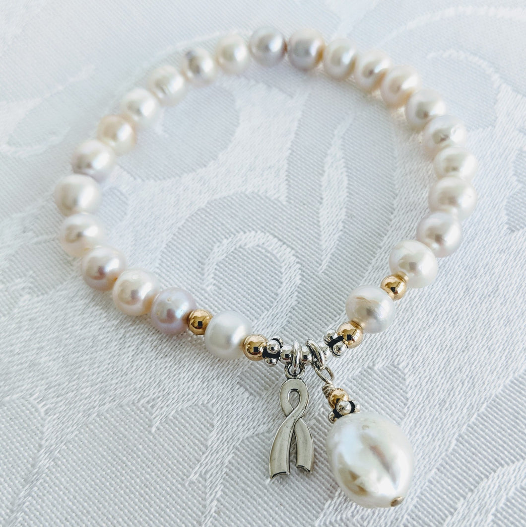 Pearl with silver awareness charm and Keshi pearl charm