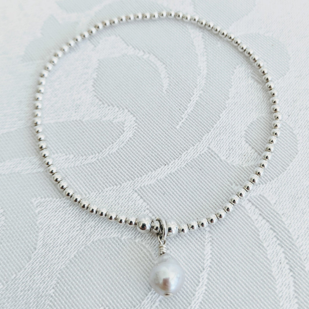 Tiny sterling silver balls with pearl charm