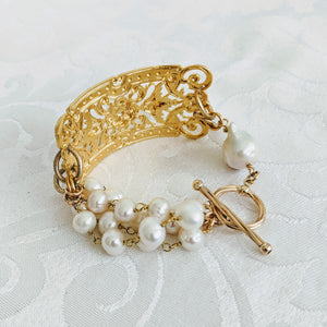 Ornate plate and pearl bracelet